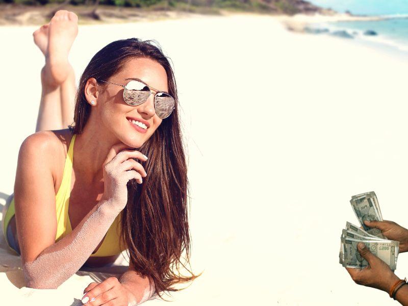 Beach scene with woman and cash in hand