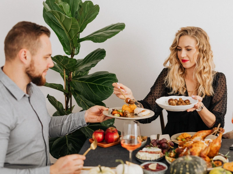 Romantic dinner scene with couple serving food